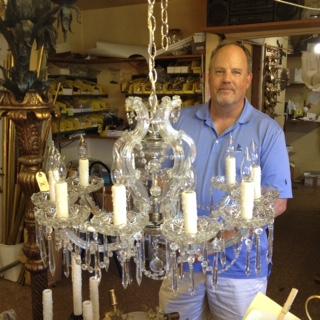 Owner Jeff Hansen with a crystal chandelier